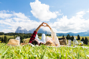 Romantic couple in love doing picnic visiting mountains alps. Boyfriend and girlfriend enjoying...