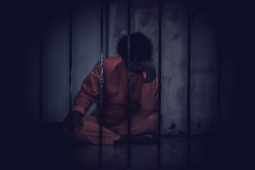 Asian man desperate at the iron prison,prisoner concept,thailand people,Hope to be free,Serious...