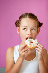 cute girl holding an appetizing glazed donut in her hands