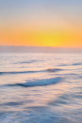 Fototapeta na wymiar Sunset over ocean waves