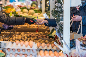 person holding a bag of fruits at market