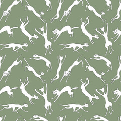 Seamless background of abstract silhouettes jumping and running white cats