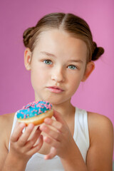 cute girl holding an appetizing glazed donut in her hands