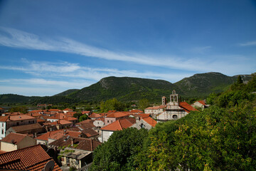 Ancient bell tower crowning the red rooftops of picturesque town