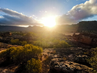Sun setting in centre / middle of Beautiful Rocky Landscape - Sun behind cliffs, valley of rocks and boulders. Rocklands, Cederberg, South Africa © Shane
