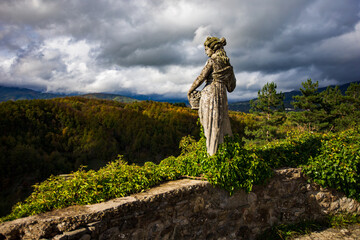 statue of woman on the hill