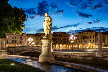 View of the canal with statues on square of Prato della Valle in Padova at night, Italy