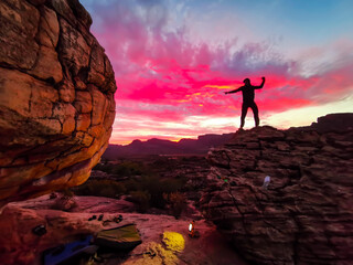 Silhouette of Man on Mountain top Summit Expressing mindfulness & Freedom for Life. Clouds, Epic Red Sky and boulders with Scenic View from the Top, Rocklands, Cederberg, South Africa , Rock Climbing