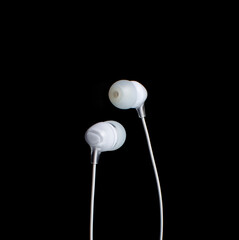 white headphones on a black background.copy space.