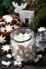 jar with sweet marshmallows and Christmas decorations, vertical top view