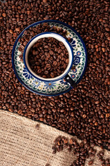 Cup of coffee, Coffee beans on the table. - obrazy, fototapety, plakaty