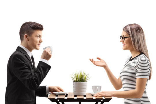 Guy In A Suit Drinking Cofee And Sitting At A Table With A Woman