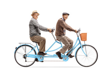 Two elderly men riding a blue tandem bicycle and smiling at camera