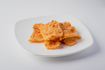 Rice cracker with flossy pork in a plate on a white background