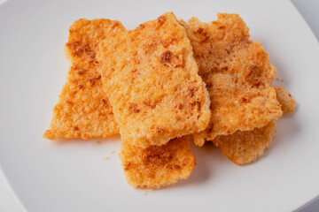 Rice cracker with flossy pork in a plate on a white background