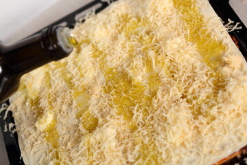 Top with grated cheese, butter and olive oil. Making Lasagna Bolognese Series.