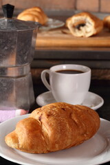 Croissant, coffee cup and moka pot