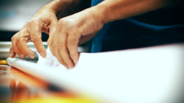 Man hands opening a big adhesive printing papaer
