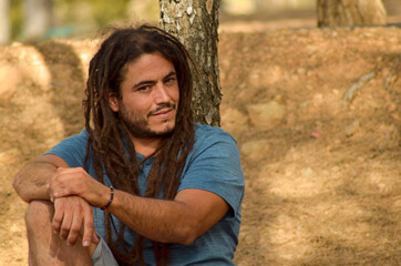 Closeup shot of an attractive man with dreads