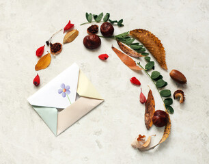 composition of envelop, leaves, flowers, chestnuts and acorns. Mail and greeting concept.