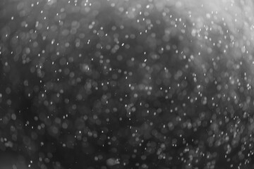 Obraz premium snow or rain bokeh texture overlay on black background.