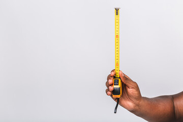African american black manhands holding measure tape and measuring value isolated over white background.