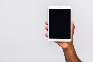 African american man holding a tablet isolated on white background. Copyspace, Close-up comcept.