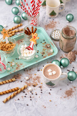 Hot Cocoa Bar with Christmas Cups and Decorations; Multiple Toppings Pictured; White and Gray Countertop