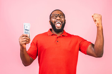 Winner! Young rich happy african american man in casual holding money dollar bills and wallet with...