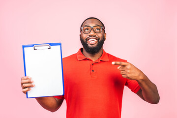 Young african american inspector man wearing glasses holding clipboard checklist with surprise face...
