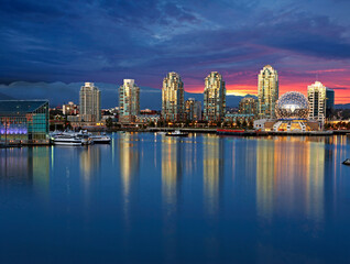 Fototapeta na wymiar Skyline of Vancouver with Telusphere science centre and Burrard Inlet with sunset 