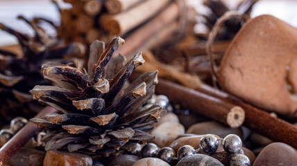 close up pinecones and wooden ornaments standing on the table. autumn and fall concept