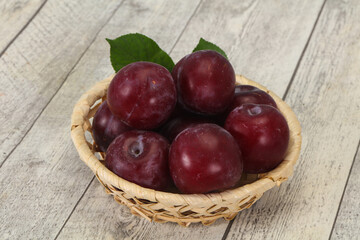 Plum heap in the wooden basket