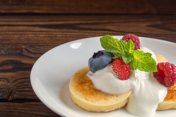 Cottage cheese pancakes, syrniki with fresh berries.