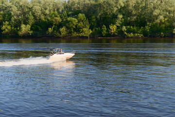 July 4, 2020: Photo of a motor boat floating on the river. Russia. Volga river in the vicinity of Cheboksary.