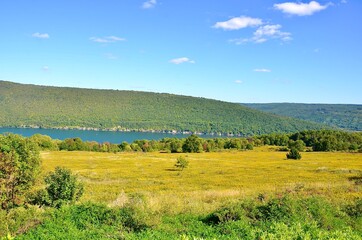 Landscape with lake and mountains, in the Finger Lakes region, New York. Early autumn scene 