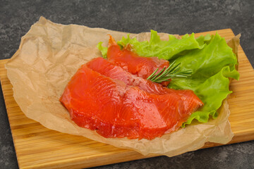 Sliced salmon fillet served rosemary