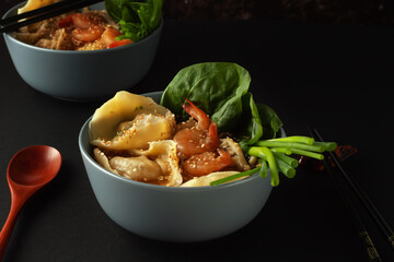 Shrimp noodle soup with wontons and spinach