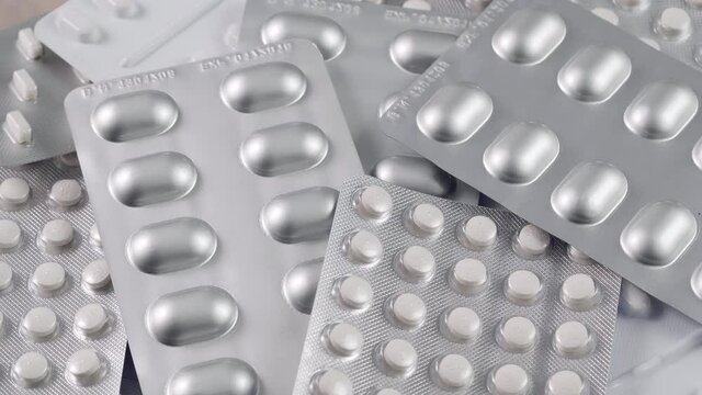Close-up view of packages with medical pills rotating. Pharmaceutical Industry. 