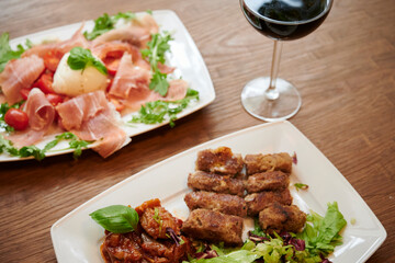 Grilled meat, glass of red wine in the restaurant