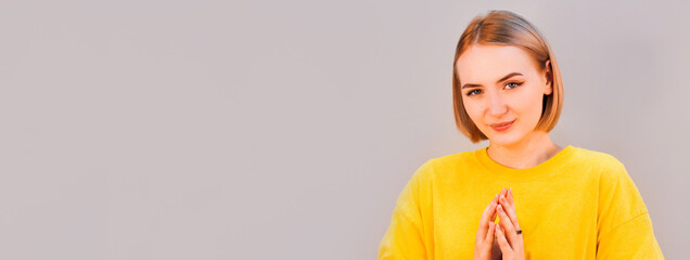 Closeup portrait of sneaky, sly, scheming young woman plotting something isolated on gray...