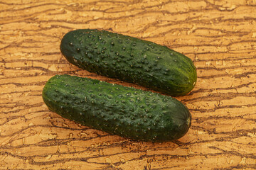 Green fresh cucumbers over background