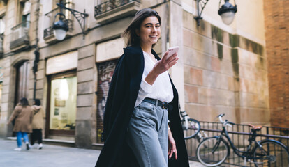 Stylish woman walking on street