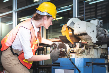 Engineers Caucasian woman  are working using steel cutting machines, which are machines used in industry plants, For industrial production, to working woman concept.