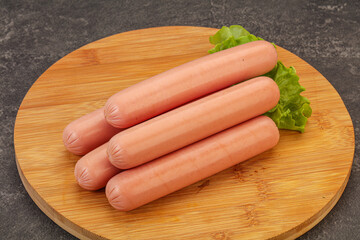 Tasty meat sausages over board