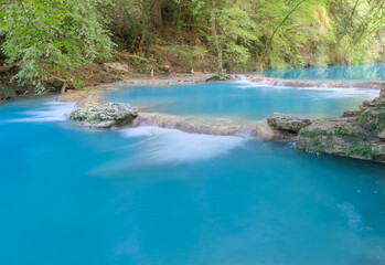 Fototapeta na wymiar Tiny waterfalls produced elsa river in the colle di val d'elsa river park tuscany italy