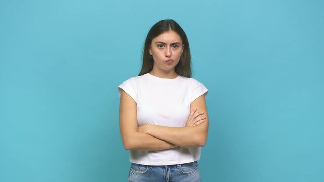 Young caucasian woman frowning face in displeasure, keeps arms folded