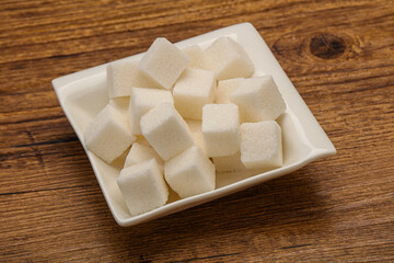Refined white sugar cubs in the bowl