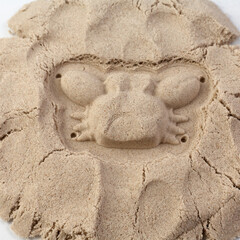 Kinetic sand background texture for use in design. Crab shape.