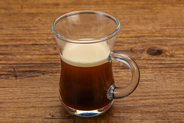 Hot Espresso coffee over wooden table